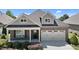 Charming home featuring a brick facade, well-manicured landscaping, and an attached two-car garage at 115 Moss Creek Pl, Fuquay Varina, NC 27526