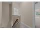 Hallway view with a stairway and window to a bathroom with a shower-tub combo at 115 Moss Creek Pl, Fuquay Varina, NC 27526