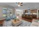 Open concept living room and kitchen with island seating and stainless steel appliances at 115 Moss Creek Pl, Fuquay Varina, NC 27526