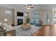 Cozy living room with a fireplace, comfortable seating, and a view to the backyard at 115 Moss Creek Pl, Fuquay Varina, NC 27526