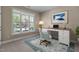 Bright office with a large window, a stylish desk, and a comfortable patterned chair at 115 Moss Creek Pl, Fuquay Varina, NC 27526