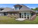 Back exterior showing a brick home, lawn, and patio at 115 Moss Creek Pl, Fuquay Varina, NC 27526
