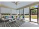 Bright sunroom with large windows, comfortable seating, and stylish decor at 115 Moss Creek Pl, Fuquay Varina, NC 27526