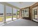 Sunroom features multiple windows, brick accent wall and ceiling fan at 115 Moss Creek Pl, Fuquay Varina, NC 27526