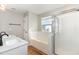 Bright bathroom featuring a dual sink vanity, soaking tub and glass shower at 11700 Coppergate Dr # 100, Raleigh, NC 27614