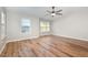 Light-filled bedroom with hardwood floors, ceiling fan, and large windows at 11700 Coppergate Dr # 100, Raleigh, NC 27614
