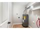 Utility room featuring a water heater and shelving for storage at 11700 Coppergate Dr # 100, Raleigh, NC 27614