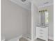 This bathroom features a shower and vanity with a modern mirror and white cabinets at 11944 Appaloosa E, Raleigh, NC 27613