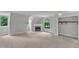 Bright, carpeted bedroom with a fireplace, walk-in closet, and plenty of natural light from large windows at 11944 Appaloosa E, Raleigh, NC 27613