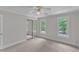 Bedroom with carpet, ceiling fan, large sliding mirrored closet and two bright windows at 11944 Appaloosa E, Raleigh, NC 27613