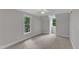 Large bedroom featuring light walls, carpet, two windows, baseboard trim and crown molding at 11944 Appaloosa E, Raleigh, NC 27613