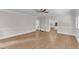 Bright, open-concept living room featuring wood floors and seamless transition to kitchen at 11944 Appaloosa E, Raleigh, NC 27613