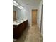Bathroom with a double sink vanity and walk-in closet at 1304 Cozart St # 109, Durham, NC 27704