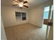 Bright bedroom featuring neutral carpet, a window with blinds, and a ceiling fan with light at 1304 Cozart St # 109, Durham, NC 27704