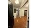 Welcoming foyer with wood flooring, a staircase to the upper level, and open view to the kitchen and living area at 1304 Cozart St # 109, Durham, NC 27704