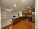 Open-concept kitchen with stainless steel appliances, granite countertops, and wood floors overlooking the living area at 1304 Cozart St # 109, Durham, NC 27704