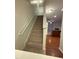 Carpeted staircase leading to the upper level, with a view of the open-concept living area and kitchen at 1304 Cozart St # 109, Durham, NC 27704