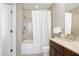 This bright bathroom features a shower over tub with tiled surround and modern vanity at 140 W Franklin St # 706, Chapel Hill, NC 27516