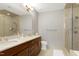 Bathroom features dual sinks, marble countertops, a walk-in shower, and a separate toilet at 140 W Franklin St # 706, Chapel Hill, NC 27516