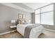 Well-lit bedroom boasts a large window, plush pillows, and decorative art at 140 W Franklin St # 706, Chapel Hill, NC 27516