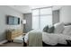 This bedroom offers a relaxing space, with a TV, light wood dresser, and comfortable furniture at 140 W Franklin St # 706, Chapel Hill, NC 27516
