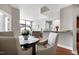 A well-lit dining area with a round table, four upholstered chairs, and hardwood floors at 140 W Franklin St # 706, Chapel Hill, NC 27516