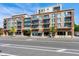 Beautiful mixed-use building featuring brick, beige concrete and black iron balconies at 140 W Franklin St # 706, Chapel Hill, NC 27516