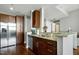 Kitchen with wooden cabinets, granite countertops, stainless steel appliances, and a breakfast bar at 140 W Franklin St # 706, Chapel Hill, NC 27516