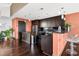 Modern kitchenette with dark cabinets, stainless steel appliances, and a breakfast bar at 140 W Franklin St # 706, Chapel Hill, NC 27516