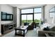 Living room with a large glass doors that lead to a balcony with scenic outdoor views at 140 W Franklin St # 706, Chapel Hill, NC 27516