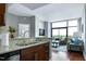 Open concept kitchen and living room feature an entertainment area with a large window and wood floors at 140 W Franklin St # 706, Chapel Hill, NC 27516