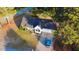 Aerial view of the home showcasing its mature trees and spacious lot in a serene neighborhood at 15 Colonial Hills Dr, Lillington, NC 27546