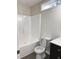 Bright bathroom with a white tub and shower combo, toilet, and window for natural light at 15 Colonial Hills Dr, Lillington, NC 27546
