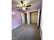 Bright bedroom featuring neutral carpet, ceiling fan, and closet space at 15 Colonial Hills Dr, Lillington, NC 27546