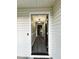 View of the foyer showing the front door opening to the updated floors and modern light fixture at 15 Colonial Hills Dr, Lillington, NC 27546