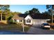 Charming single-story home featuring a well-manicured lawn and a convenient two-car garage at 15 Colonial Hills Dr, Lillington, NC 27546