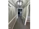 View down the hallway featuring updated floors, fresh paint, and decorative lighting at 15 Colonial Hills Dr, Lillington, NC 27546