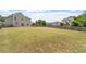 Large backyard with a long fence, flat lawn, and concrete patio at 15 Epping Ct, Durham, NC 27703