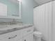 Bathroom vanity featuring marble countertops, white cabinets, and modern fixtures at 15 Epping Ct, Durham, NC 27703