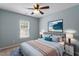 Serene bedroom with soft blue walls, a comfortable bed, and tasteful decor, creating a peaceful and relaxing retreat at 15 Epping Ct, Durham, NC 27703