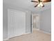 Bedroom featuring closet with bi-fold doors and hallway to a full bathroom at 15 Epping Ct, Durham, NC 27703