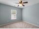 Cozy bedroom with carpeted floors and a ceiling fan at 15 Epping Ct, Durham, NC 27703