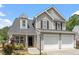 Charming two-story home featuring a two-car garage, complemented by a well-manicured front lawn and lush landscaping at 15 Epping Ct, Durham, NC 27703