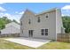 Back exterior view of a two-story house with gray siding and a concrete patio at 15 Epping Ct, Durham, NC 27703