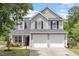Charming two-story home featuring a two-car garage, complemented by a well-manicured front lawn and lush landscaping at 15 Epping Ct, Durham, NC 27703