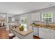 Open-concept kitchen with an island, granite countertops, stainless steel appliances, and plenty of natural light at 15 Epping Ct, Durham, NC 27703