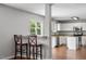 Bright and spacious kitchen featuring white cabinets and a breakfast bar with two stools at 15 Epping Ct, Durham, NC 27703