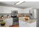 Modern kitchen featuring stainless steel appliances, granite countertops, and ample cabinet space for a functional cooking area at 15 Epping Ct, Durham, NC 27703