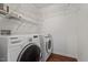 Efficient laundry room with modern Samsung washer and dryer and shelving units at 15 Epping Ct, Durham, NC 27703