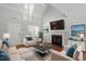 Bright living room with vaulted ceilings, a cozy fireplace, and neutral decor for a comfortable and inviting atmosphere at 15 Epping Ct, Durham, NC 27703